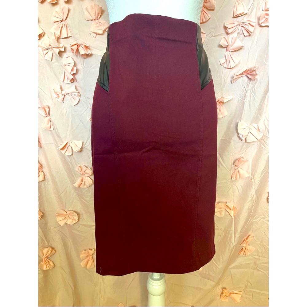 Bebe brand. Form fitting skirt, spandex material. Purple and black.